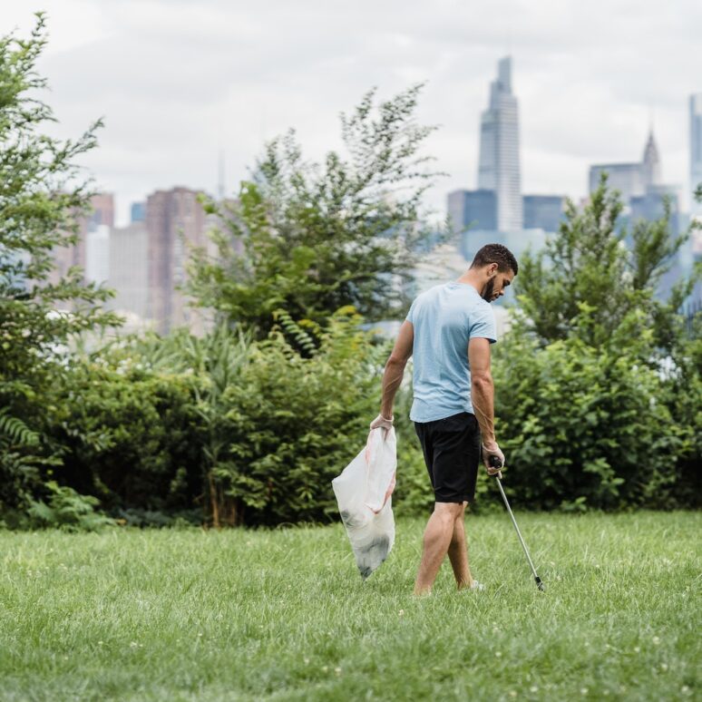 Man picking litter. Source: Photo by Lara Jameson: https://www.pexels.com/photo/city-park-outdoors-bag-9324307/