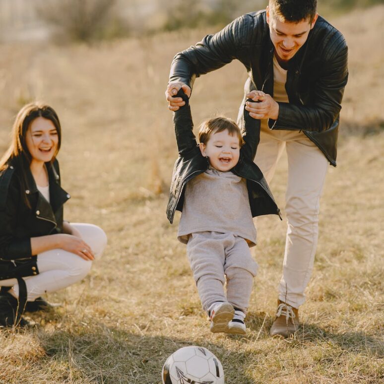 Photo by Gustavo Fring: https://www.pexels.com/photo/photo-of-family-having-fun-with-soccer-ball-4148842/